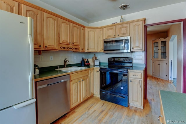 6788 Pierce Way, Arvada, CO 80003 - kitchen with appliances with stainless steel finishes, light wood finished floors, decorative backsplash, and light brown cabinetry