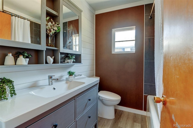 6788 Pierce Way, Arvada, CO 80003 - bathroom with vanity, wood finished floors, and shower / tub combo