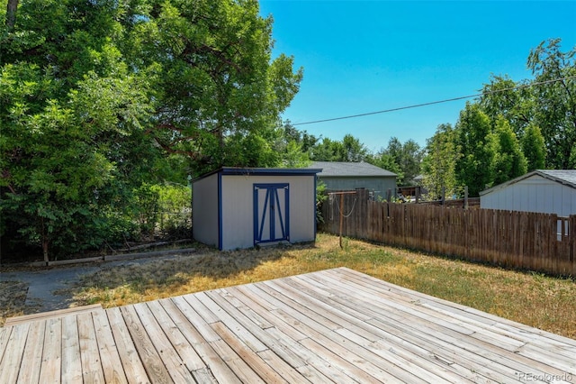 6788 Pierce Way, Arvada, CO 80003 - wooden deck featuring a shed, a fenced backyard, and view of wooded area