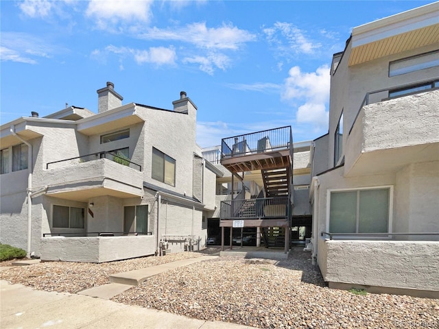 back of property with a balcony