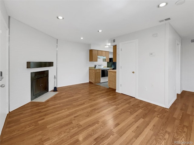 unfurnished living room featuring light wood-type flooring