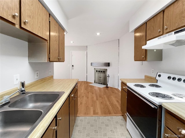 kitchen with a brick fireplace, sink, and white electric range