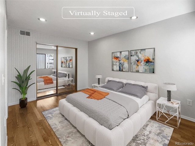 bedroom featuring hardwood / wood-style floors and a closet