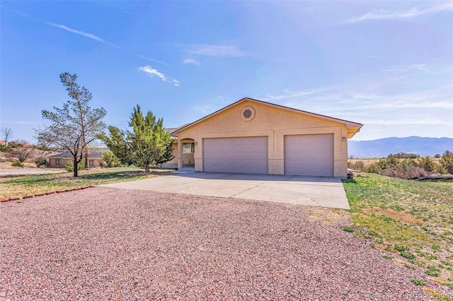1041 Rockafellow Ct, Canon City, CO 81212 - ranch-style house featuring a garage, a mountain view, and stucco siding