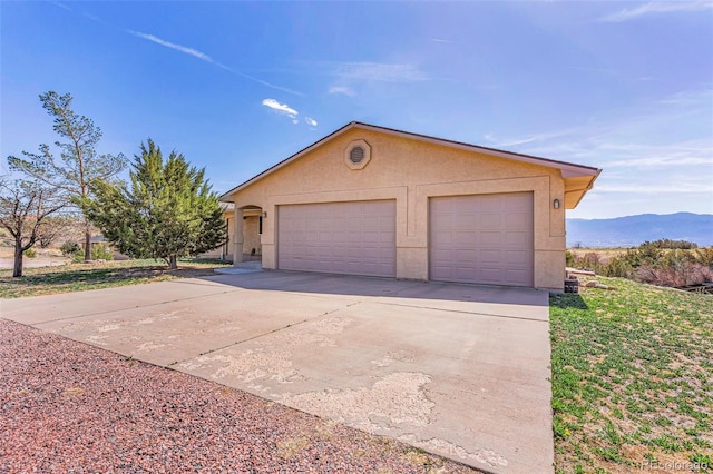 1041 Rockafellow Ct, Canon City, CO 81212 - exterior space featuring a detached garage, a mountain view, and stucco siding