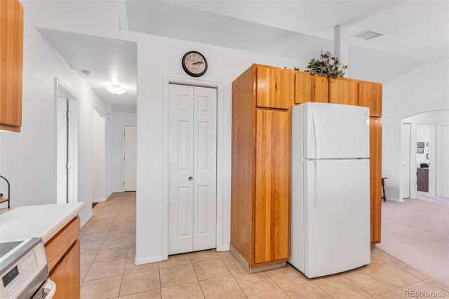 1041 Rockafellow Ct, Canon City, CO 81212 - kitchen with visible vents, range, light tile patterned floors, light countertops, and freestanding refrigerator