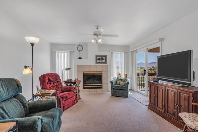 1041 Rockafellow Ct, Canon City, CO 81212 - living room featuring carpet floors, a ceiling fan, a wealth of natural light, and a tile fireplace