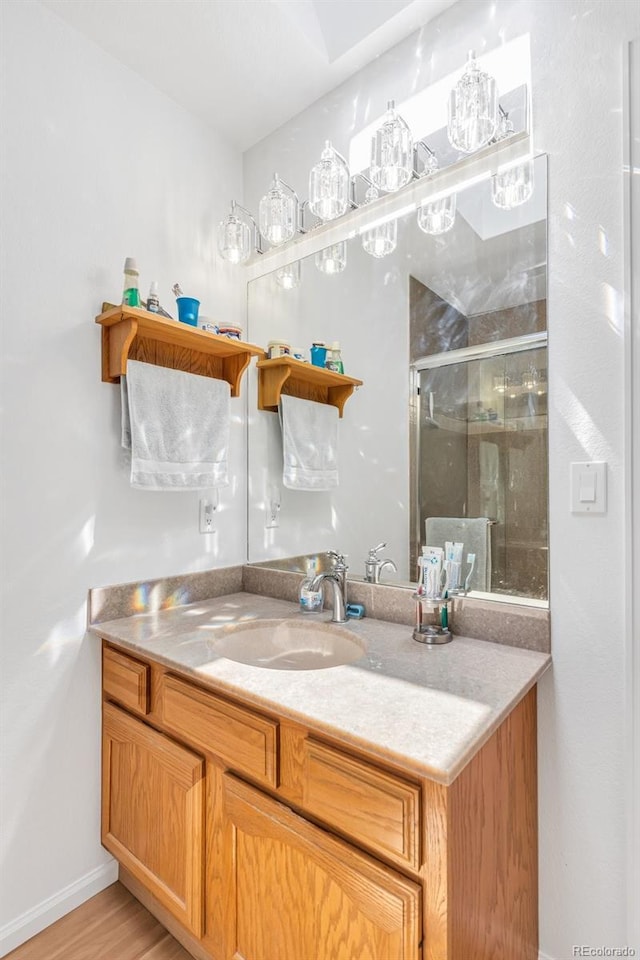 1041 Rockafellow Ct, Canon City, CO 81212 - full bath with vanity, baseboards, wood finished floors, and a stall shower