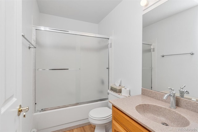 1041 Rockafellow Ct, Canon City, CO 81212 - bathroom with toilet, wood finished floors, shower / bath combination with glass door, and vanity