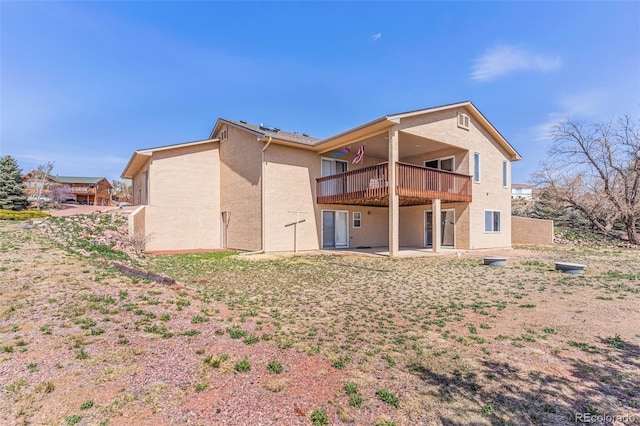 1041 Rockafellow Ct, Canon City, CO 81212 - rear view of house with a patio area, stucco siding, and a wooden deck
