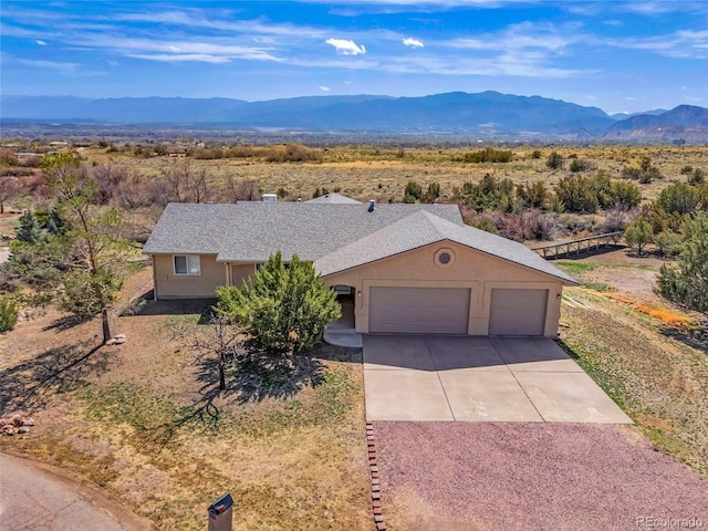1041 Rockafellow Ct, Canon City, CO 81212 - single story home featuring roof with shingles, a garage, stucco siding, a mountain view, and concrete driveway