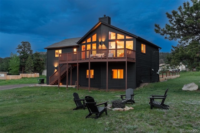 28364 Tresine Dr, Evergreen, CO 80439 - rear view of house featuring an outdoor fire pit, stairs, a wooden deck, a chimney, and a yard