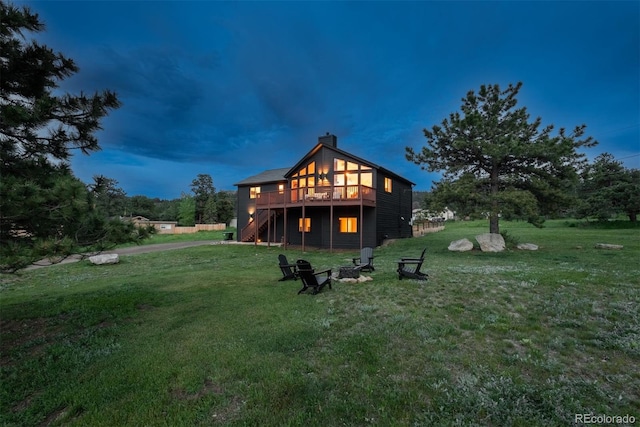 28364 Tresine Dr, Evergreen, CO 80439 - rear view of property with stairs, a deck, a lawn, an outdoor fire pit, and a chimney