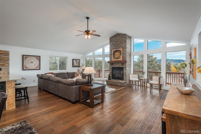 28364 Tresine Dr, Evergreen, CO 80439 - living room featuring a fireplace, a ceiling fan, high vaulted ceiling, and dark wood-style flooring