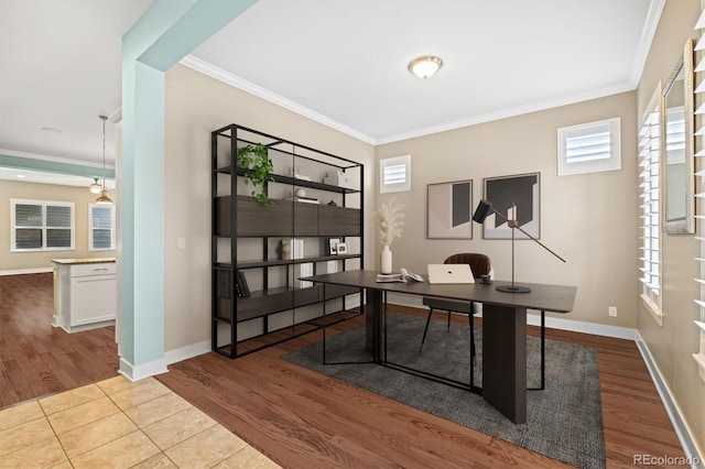 office space featuring crown molding, baseboards, and wood finished floors