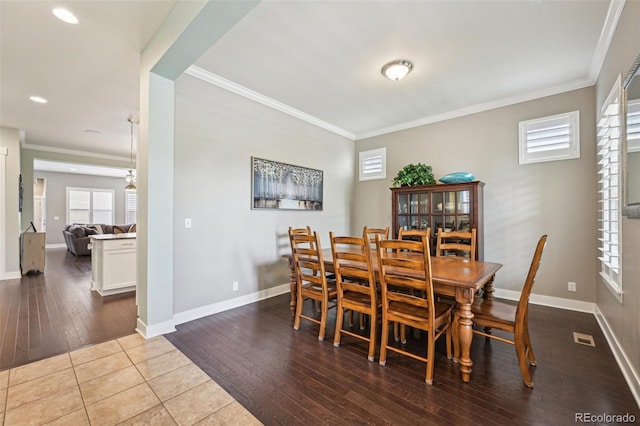 11346 E 27th Ave, Denver, CO 80238 - dining space featuring crown molding, wood-type flooring, baseboards, and recessed lighting