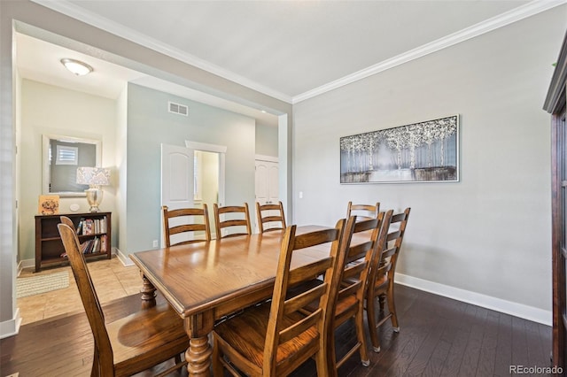 11346 E 27th Ave, Denver, CO 80238 - dining space with baseboards, hardwood / wood-style floors, and crown molding