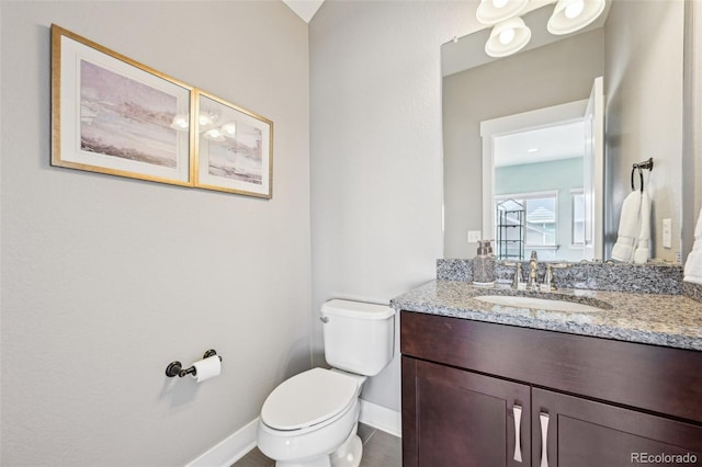 11346 E 27th Ave, Denver, CO 80238 - bathroom with baseboards, toilet, and vanity