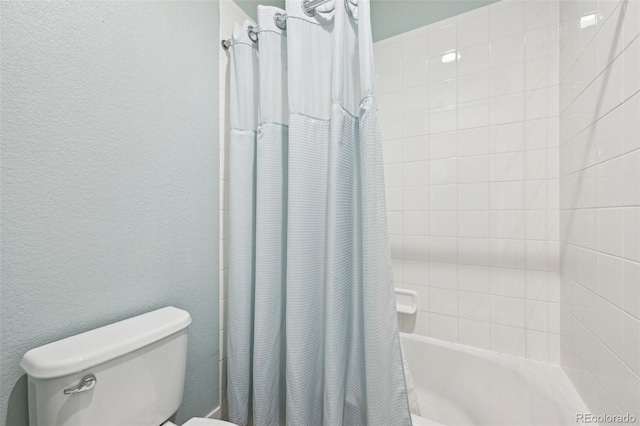 11346 E 27th Ave, Denver, CO 80238 - bathroom featuring toilet, shower / bath combo with shower curtain, and a textured wall