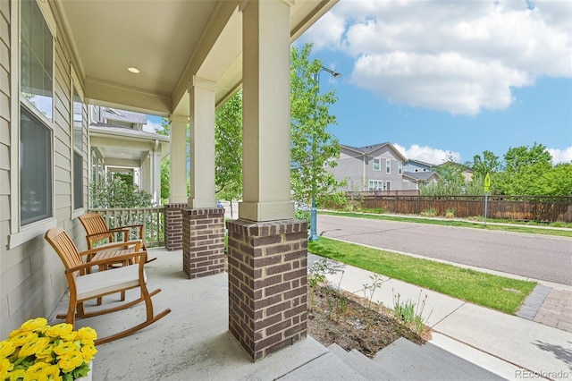 11346 E 27th Ave, Denver, CO 80238 - view of patio / terrace featuring covered porch and fence
