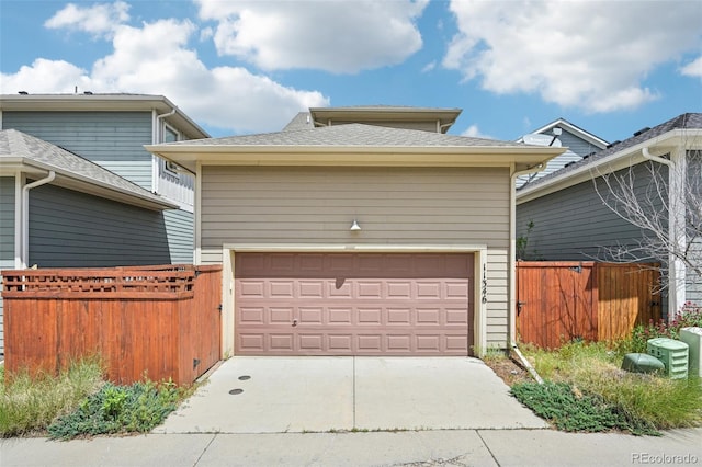 11346 E 27th Ave, Denver, CO 80238 - garage featuring fence and concrete driveway