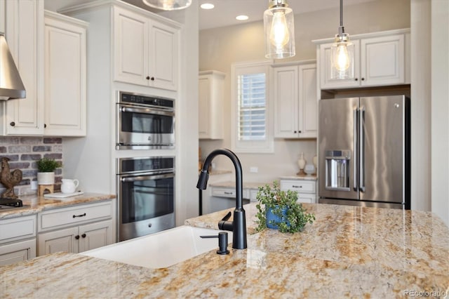 1950 W 67th Ave, Denver, CO 80221 - kitchen with recessed lighting, appliances with stainless steel finishes, a sink, decorative light fixtures, and backsplash