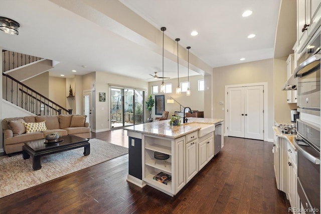 1950 W 67th Ave, Denver, CO 80221 - kitchen featuring dark wood finished floors, light stone countertops, a sink, and appliances with stainless steel finishes