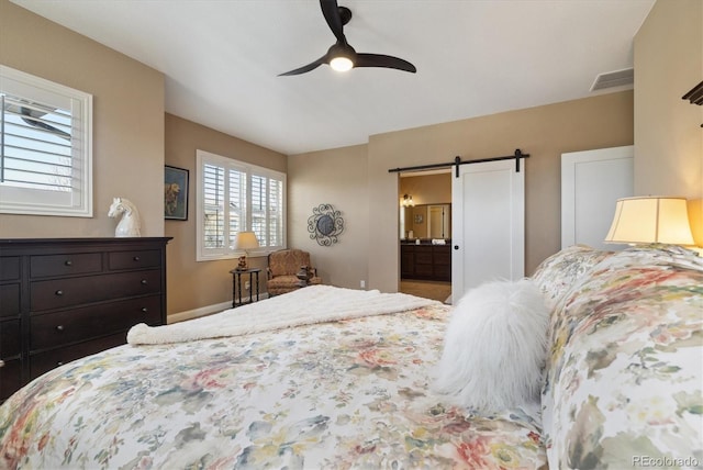 1950 W 67th Ave, Denver, CO 80221 - bedroom featuring ensuite bath, a ceiling fan, visible vents, a barn door, and baseboards