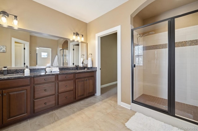 1950 W 67th Ave, Denver, CO 80221 - bathroom with a sink, tile patterned floors, double vanity, and a stall shower