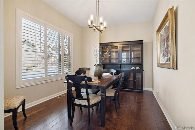 1950 W 67th Ave, Denver, CO 80221 - dining area with a chandelier, dark wood-style floors, and baseboards