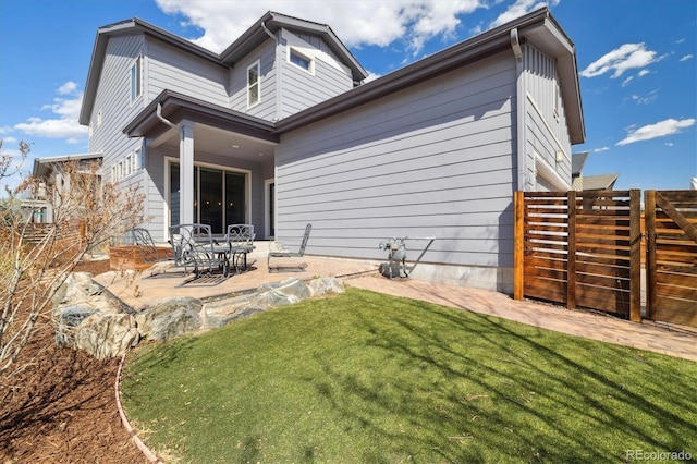 1950 W 67th Ave, Denver, CO 80221 - back of property with a patio, a yard, and fence