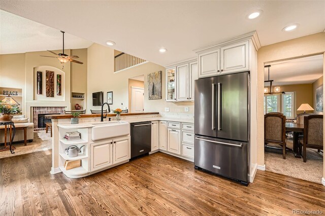 11522 Pine Grove Ln, Parker, CO 80138 - kitchen with high quality fridge, dishwashing machine, a sink, a peninsula, and ceiling fan