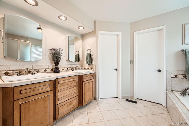 11522 Pine Grove Ln, Parker, CO 80138 - full bath featuring double vanity, a relaxing tiled tub, recessed lighting, and tile patterned floors