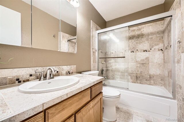11522 Pine Grove Ln, Parker, CO 80138 - bathroom featuring toilet, vanity, and enclosed tub / shower combo