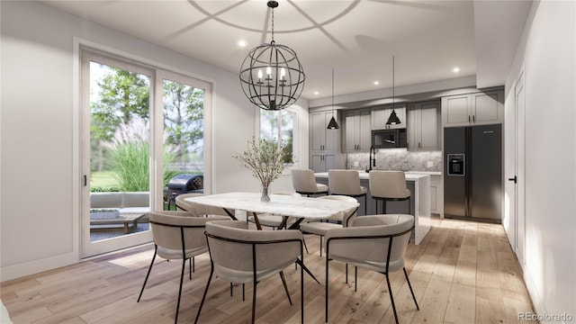 dining space featuring recessed lighting, light wood-type flooring, baseboards, and a notable chandelier