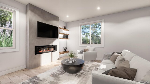 living room with recessed lighting, a large fireplace, baseboards, and wood finished floors