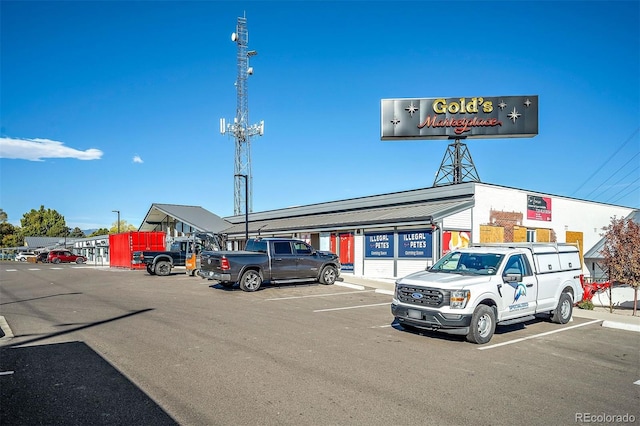 view of property featuring uncovered parking