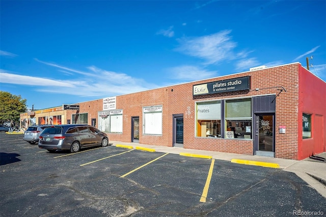 view of building exterior featuring uncovered parking