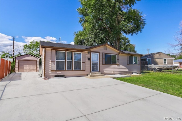 single story home featuring a detached garage, fence, an outdoor structure, concrete driveway, and a front yard