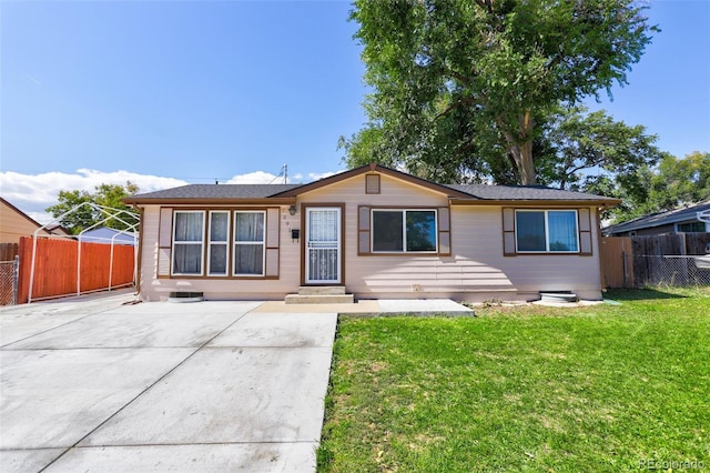 ranch-style house with a front yard and fence