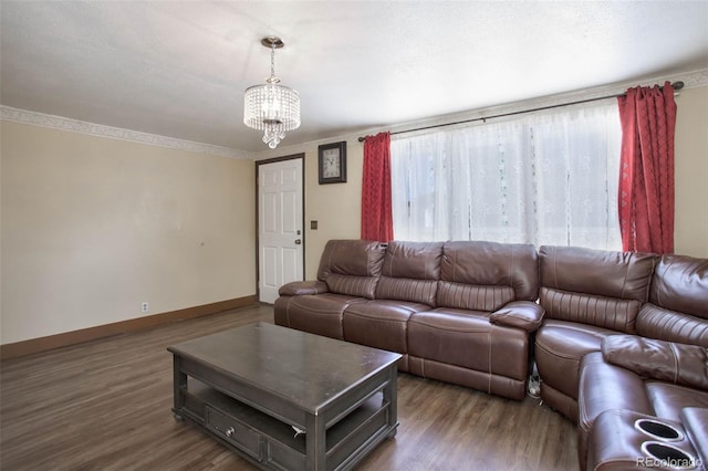 living room with wood finished floors, a notable chandelier, a healthy amount of sunlight, and baseboards