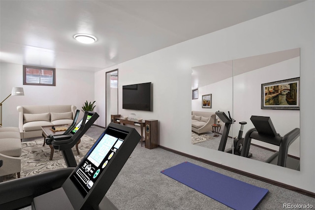 exercise room featuring baseboards and carpet