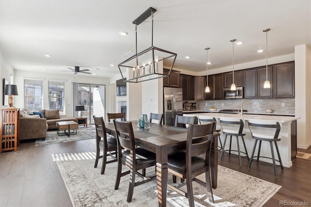 dining room featuring ceiling fan and dark hardwood / wood-style flooring