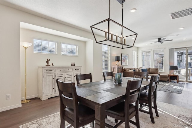 dining area with hardwood / wood-style floors and ceiling fan