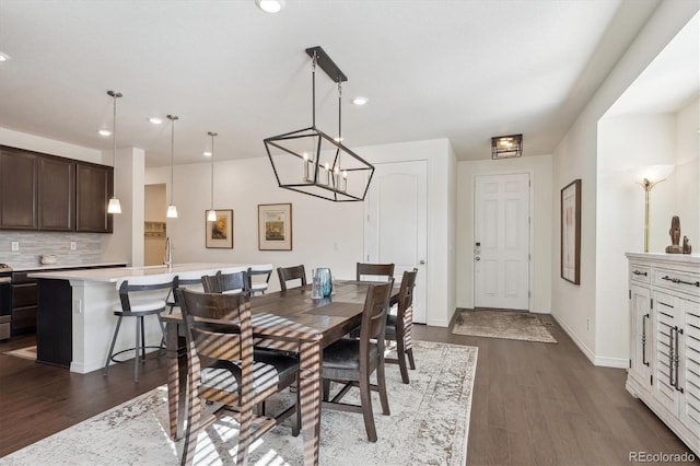 dining space with dark hardwood / wood-style flooring