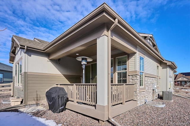 view of side of home with cooling unit and a porch