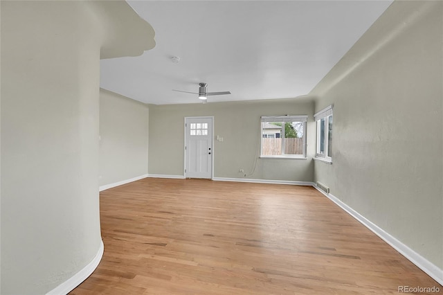 entryway featuring light wood-style floors, a ceiling fan, and baseboards