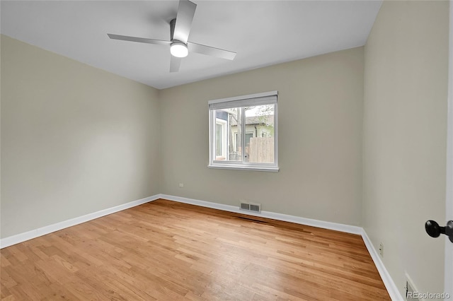 empty room with light wood finished floors, ceiling fan, and baseboards