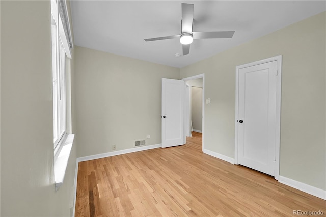unfurnished bedroom featuring light wood finished floors, baseboards, and ceiling fan