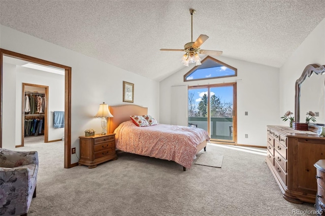 carpeted bedroom with baseboards, a ceiling fan, access to exterior, vaulted ceiling, and a textured ceiling